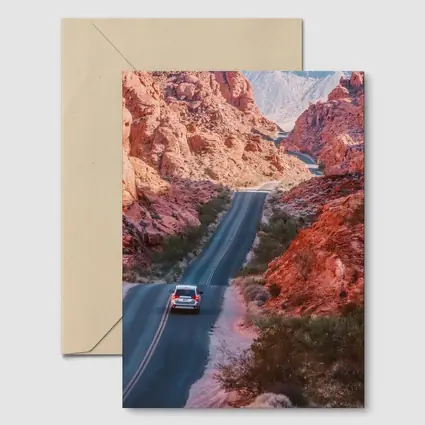 SUV Driving Through Red Rock Canyon Road
