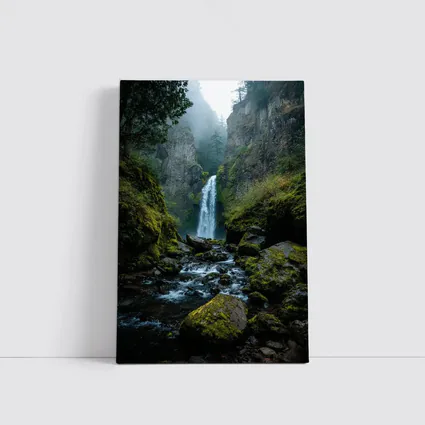 Misty Waterfall Cascading Over Mossy Rocks