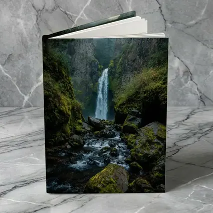 Misty Waterfall Cascading Over Mossy Rocks