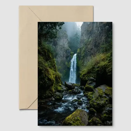 Misty Waterfall Cascading Over Mossy Rocks