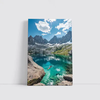 Person Swimming Alpine Lake Jagged Mountain Peaks