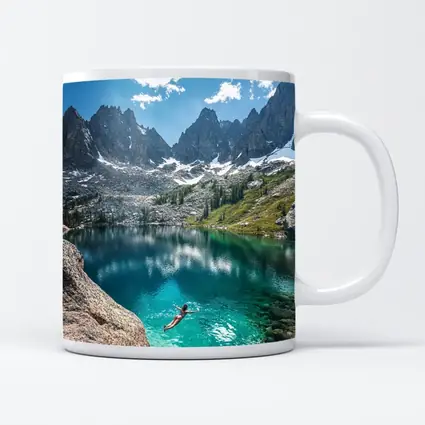 Person Swimming Alpine Lake Jagged Mountain Peaks