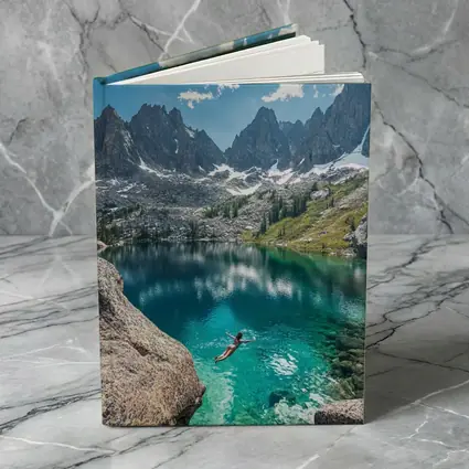 Person Swimming Alpine Lake Jagged Mountain Peaks