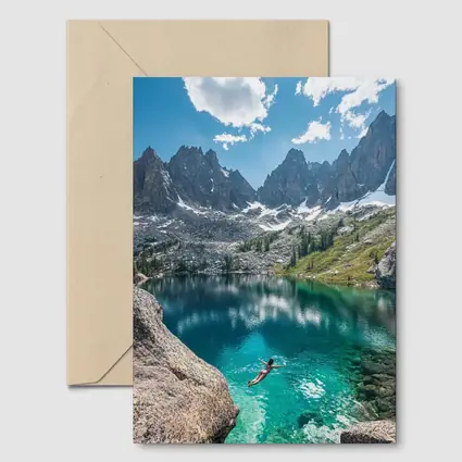 Person Swimming Alpine Lake Jagged Mountain Peaks
