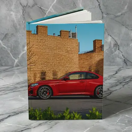 Red BMW M2 Parked Against Brick Wall
