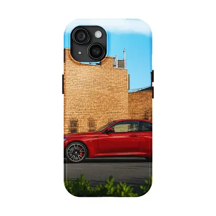 Red BMW M2 Parked Against Brick Wall