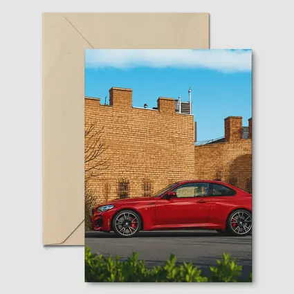 Red BMW M2 Parked Against Brick Wall