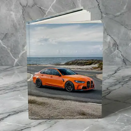 BMW M3 Orange Sedan Coastal Road Shot