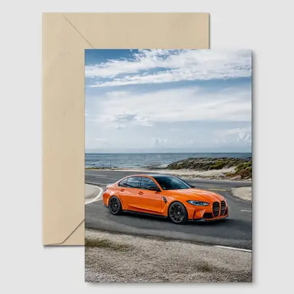 BMW M3 Orange Sedan Coastal Road Shot