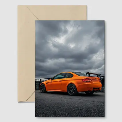 BMW M3 GTS Orange Under Stormy Sky
