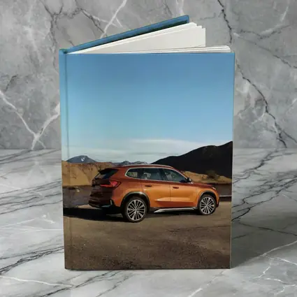 BMW X1 Orange SUV Desert Mountain Backdrop