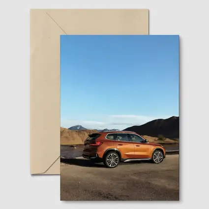 BMW X1 Orange SUV Desert Mountain Backdrop