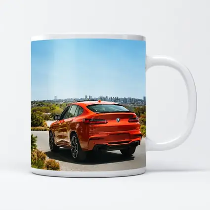 BMW X4 M Orange Rear City Skyline