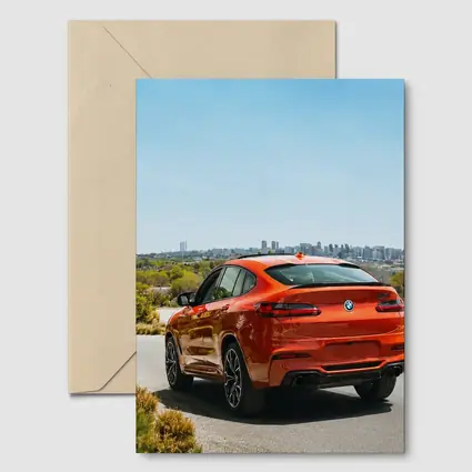 BMW X4 M Orange Rear City Skyline