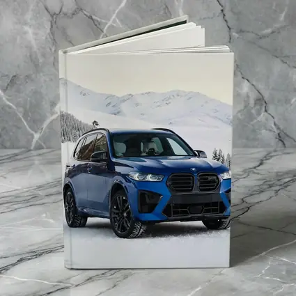 BMW X5M Blue SUV Snowy Mountain Setting