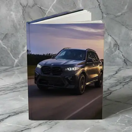 BMW X5M Matte Black Driving Sunset Road