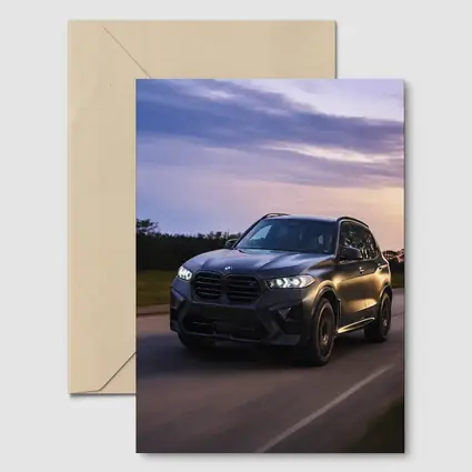 BMW X5M Matte Black Driving Sunset Road