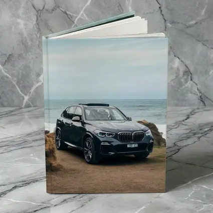 BMW X5 Parked by Coastal Rocky Shore
