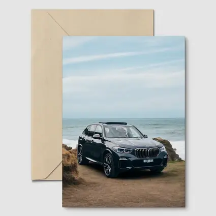 BMW X5 Parked by Coastal Rocky Shore