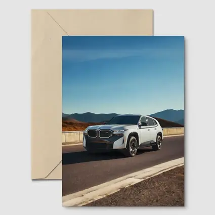 BMW XM White SUV Mountain Highway Drive