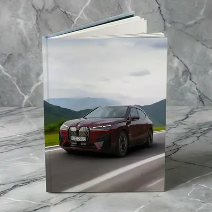 BMW iX Red SUV Mountain Road Drive