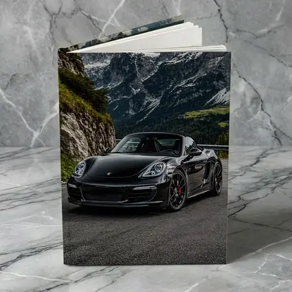 Black Porsche Boxster on Alpine Mountain Road