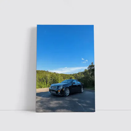 Black Cadillac CTS Parked Against Blue Sky