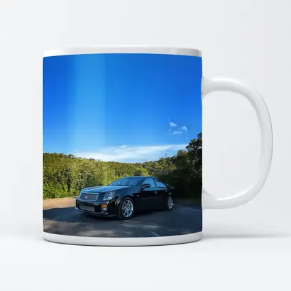 Black Cadillac CTS Parked Against Blue Sky