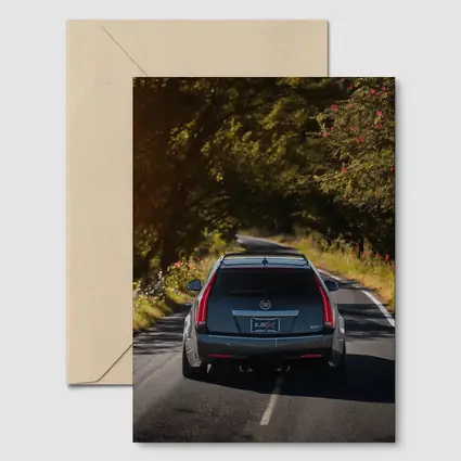 Cadillac CTS Wagon Driving Through Forest Road