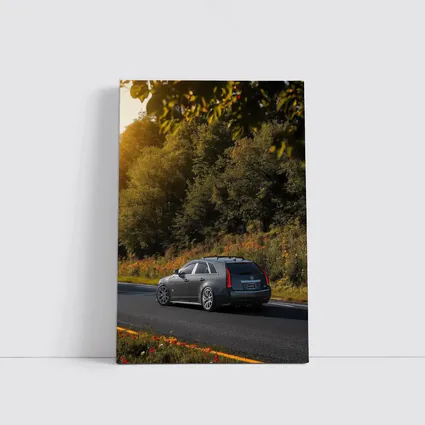 Cadillac CTS Wagon Rolling Through Forest Road