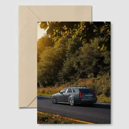 Cadillac CTS Wagon Rolling Through Forest Road