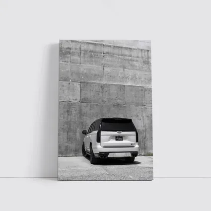White Cadillac Escalade Against Concrete Wall