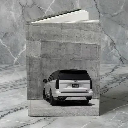 White Cadillac Escalade Against Concrete Wall