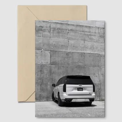 White Cadillac Escalade Against Concrete Wall