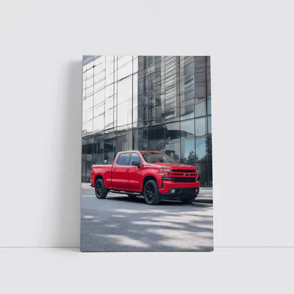 Red Chevrolet Silverado Parked by Glass Building
