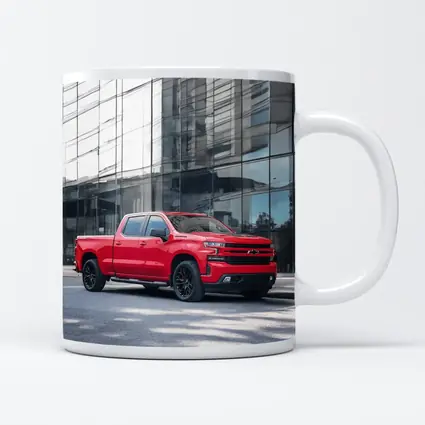 Red Chevrolet Silverado Parked by Glass Building