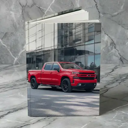 Red Chevrolet Silverado Parked by Glass Building
