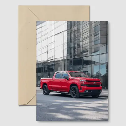 Red Chevrolet Silverado Parked by Glass Building