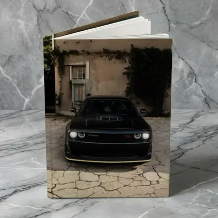 Black Dodge Challenger Parked Before Old House