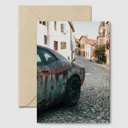 Rusty Dodge Challenger on Cobblestone Street