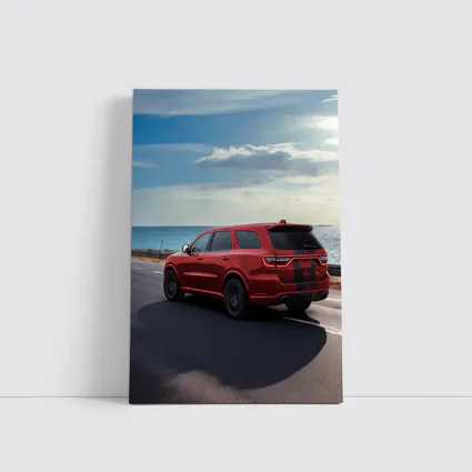 Red Dodge Durango Driving Along Coastal Road