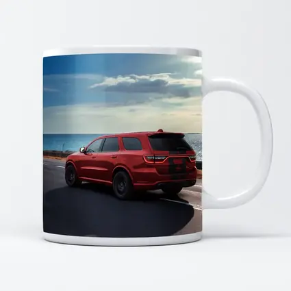 Red Dodge Durango Driving Along Coastal Road