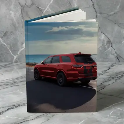 Red Dodge Durango Driving Along Coastal Road