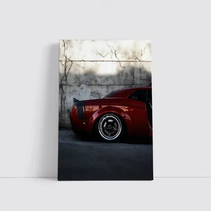 Red Dodge Challenger Parked Against Concrete Wall