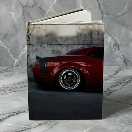 Red Dodge Challenger Parked Against Concrete Wall