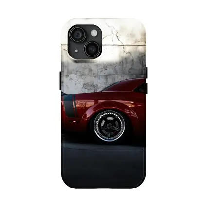 Red Dodge Challenger Parked Against Concrete Wall