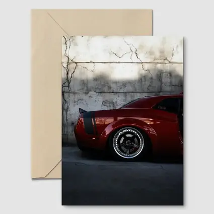 Red Dodge Challenger Parked Against Concrete Wall