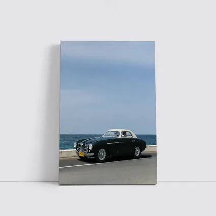 Classic Ferrari Coupe Driving Along Coastal Road