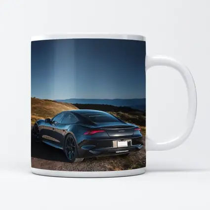 Karma Revero Dark Sedan Hillside Blue Sky