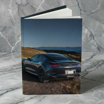 Karma Revero Dark Sedan Hillside Blue Sky